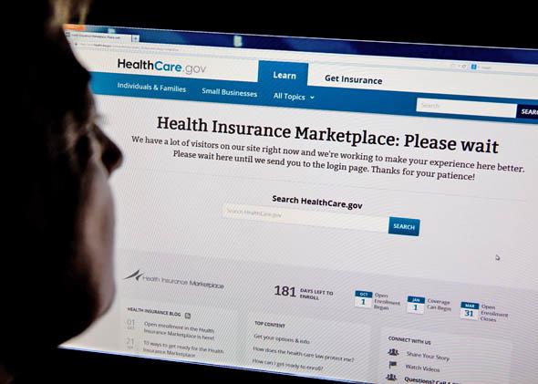 A woman looks at the Healthcare.gov insurance exchange website. 