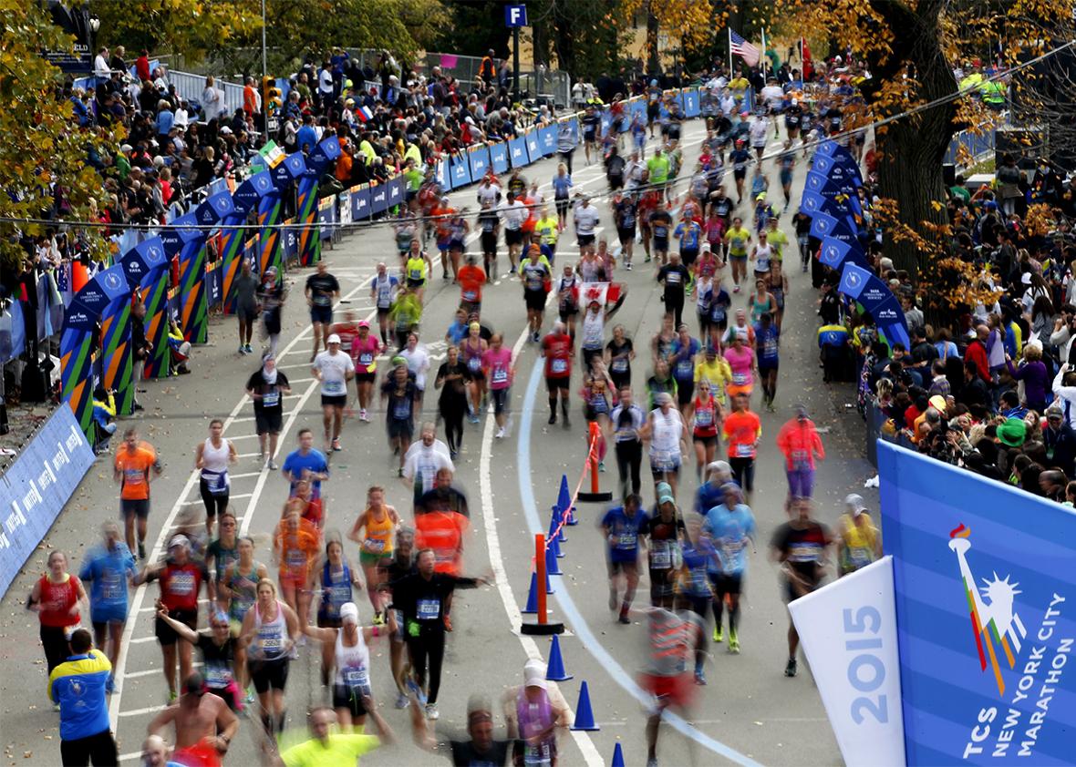 Runners run across the finish line at the 2015 New York City Marathon in New York's Central Park, November 1, 2015. 
