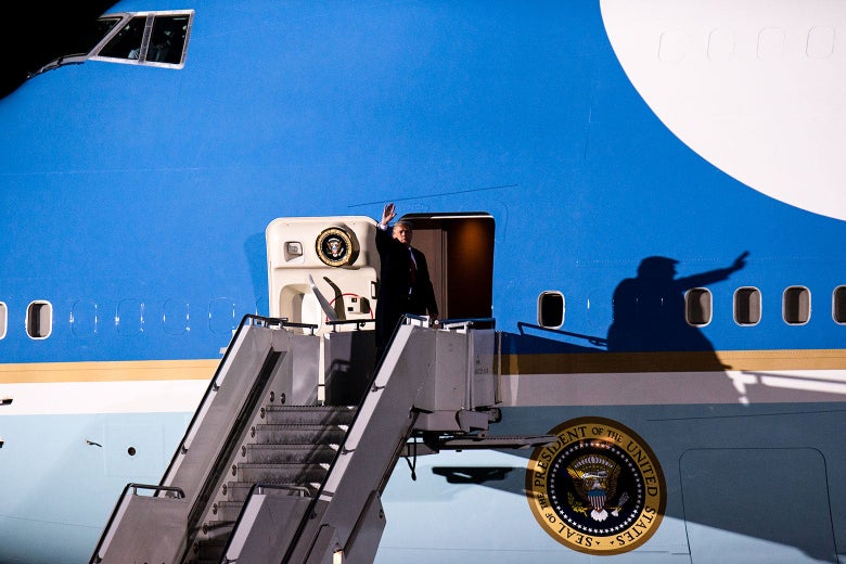 Trump waves as he boards Air Force One.