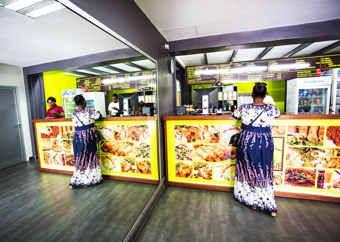 A customer at Saveurs d'Asie, a takeout chain in Senegal run by the son of a Vietnamese immigrant.