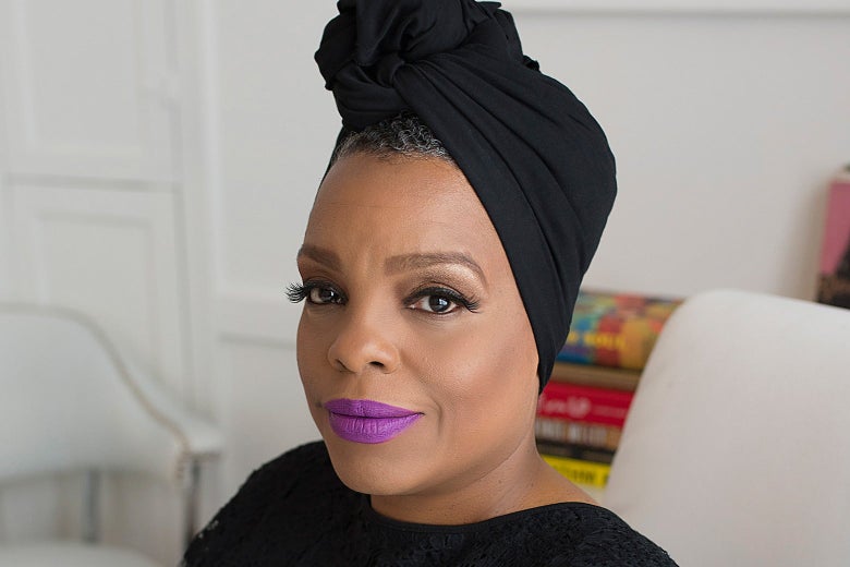A confident-looking Black woman wearing bright lipstick.