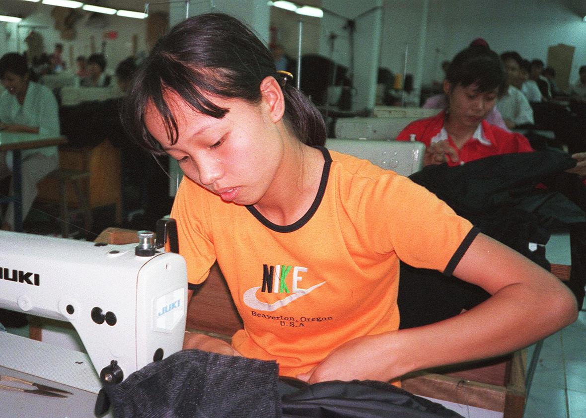 File photo dated 15 October 1998 shows a young female worker stiching together garments for export from Vinh Phat Export Garment Co., a privately owned garment company on the outskirts of Hanoi, Vietnam.  