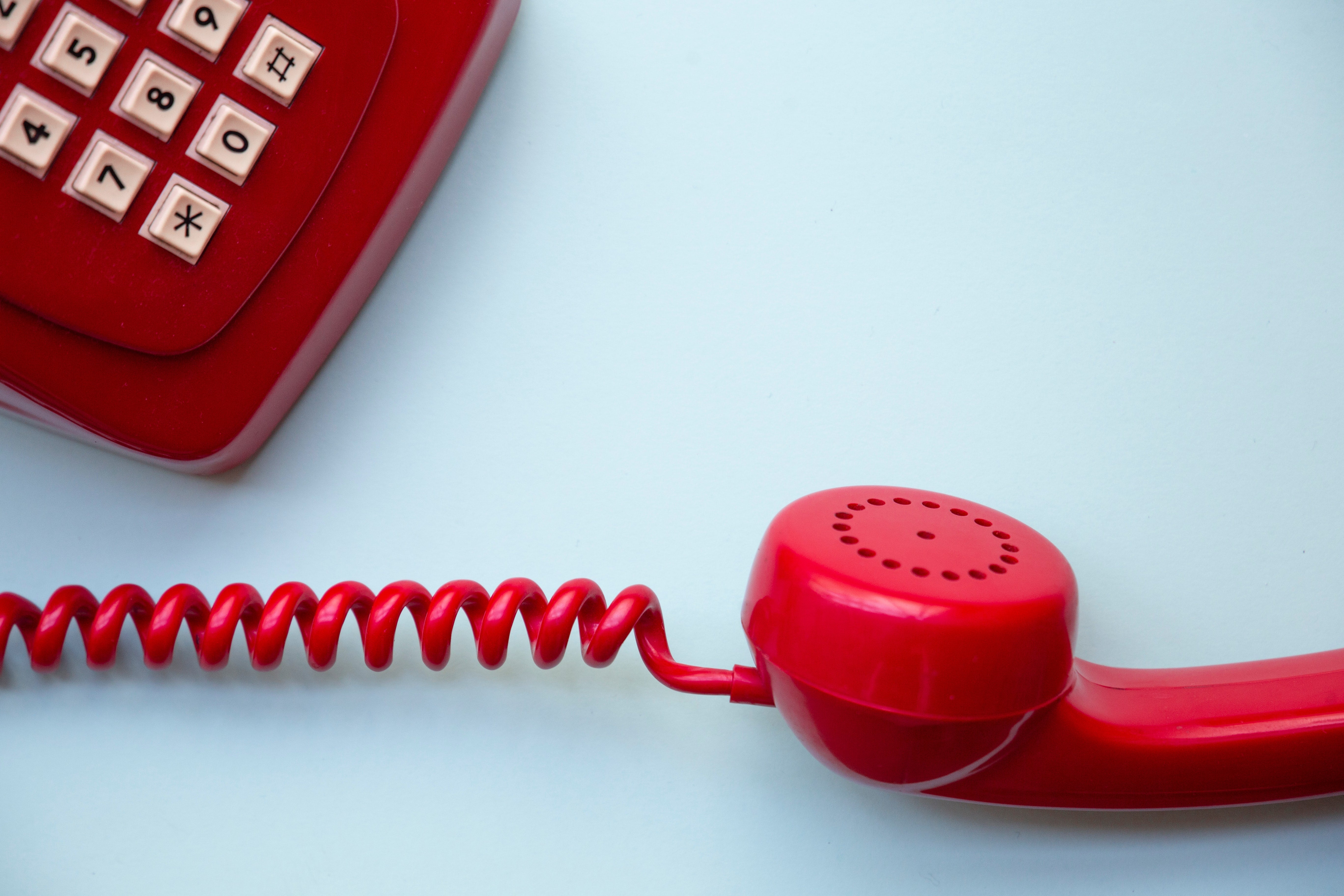 A red corded telephone