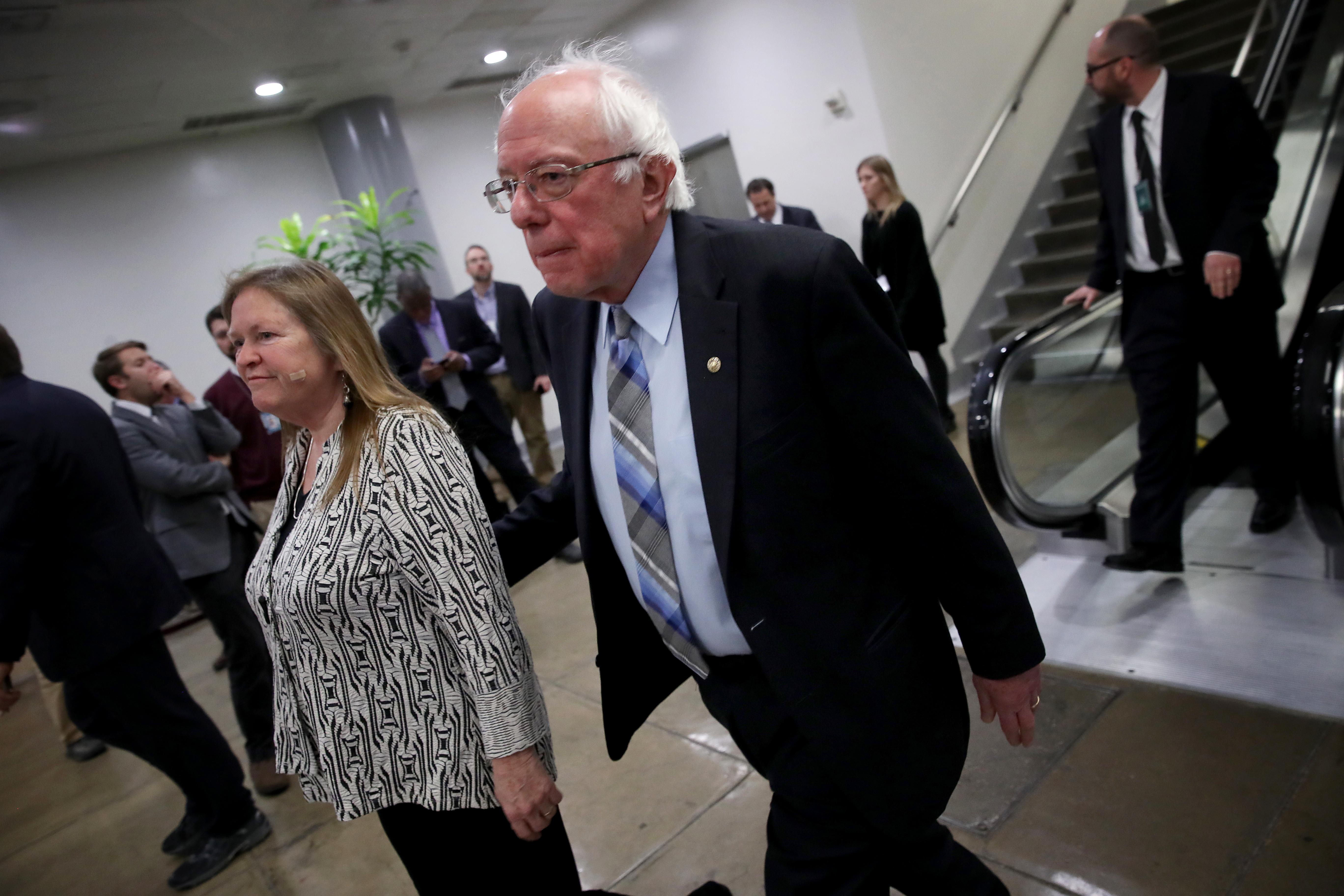 WASHINGTON, DC - JANUARY 31: Sen. Bernie Sanders (I-VT) walks with his wife Jane after leaving the Senate floor for a vote on legislation advancing Senate Majority Leader Mitch McConnell's plan voicing opposition to U.S. President Donald Trump's intention of withdrawing U.S. troops from Afghanistan and Syria on January 31, 2019 in Washington, DC. The Senate voted in overwhelmingly bipartisan fashion in favor of the legislation, rebuking President Trump's policy. (Photo by Win McNamee/Getty Images)