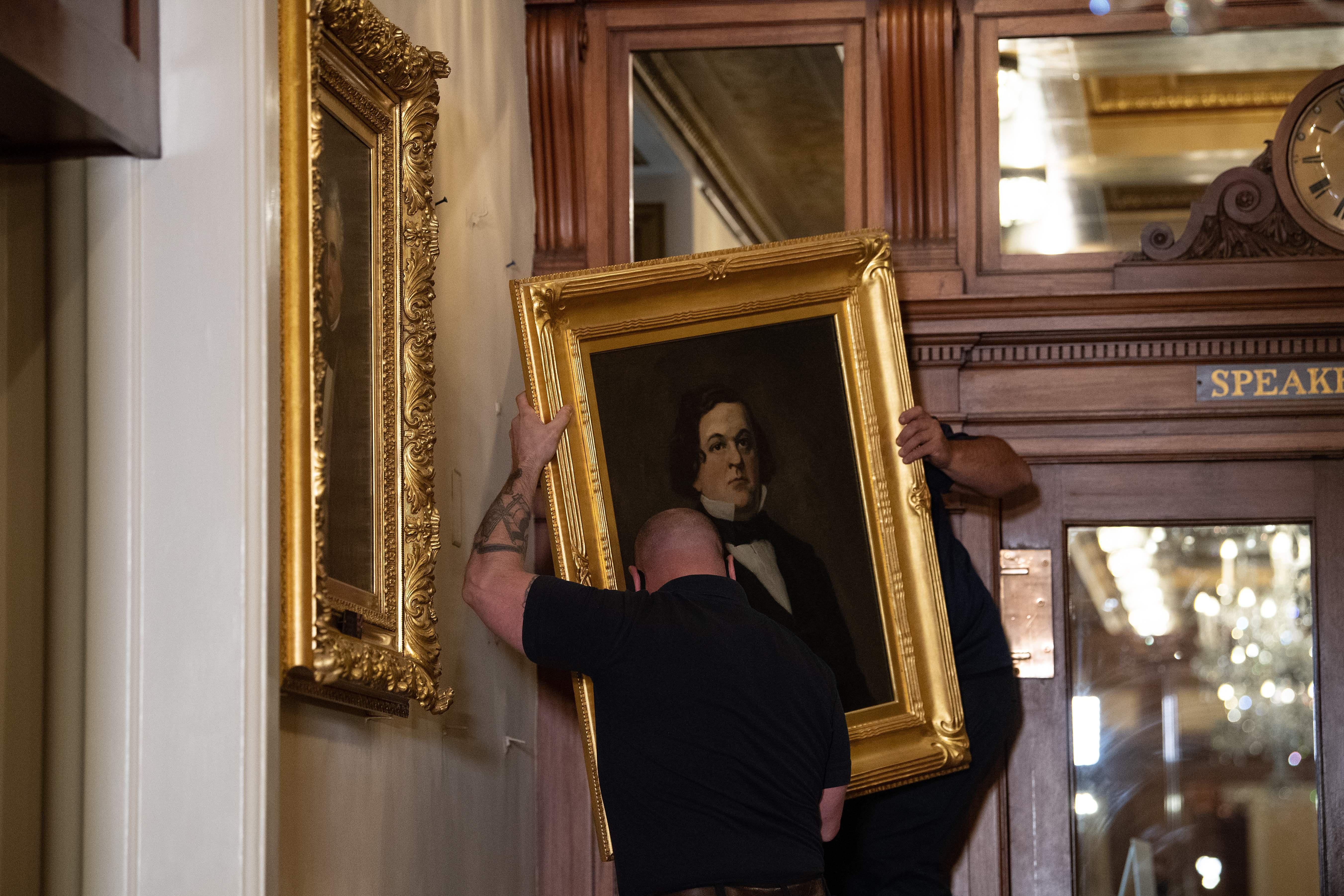 Workers remove a painting of former confederate House Speaker Howell Cobb of Georgia, from the Speakers lobby in the Capitol building. 