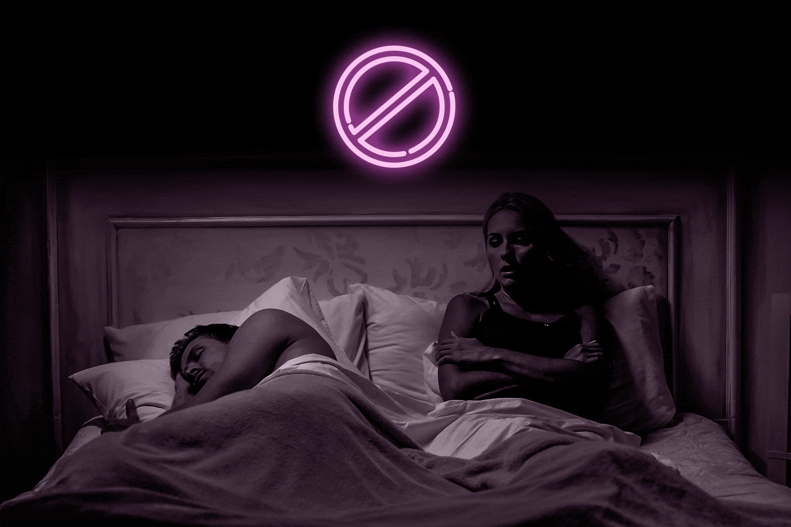 A woman sits up in bed frustrated while a man sleeps. A neon "no entry" sign blinks above.