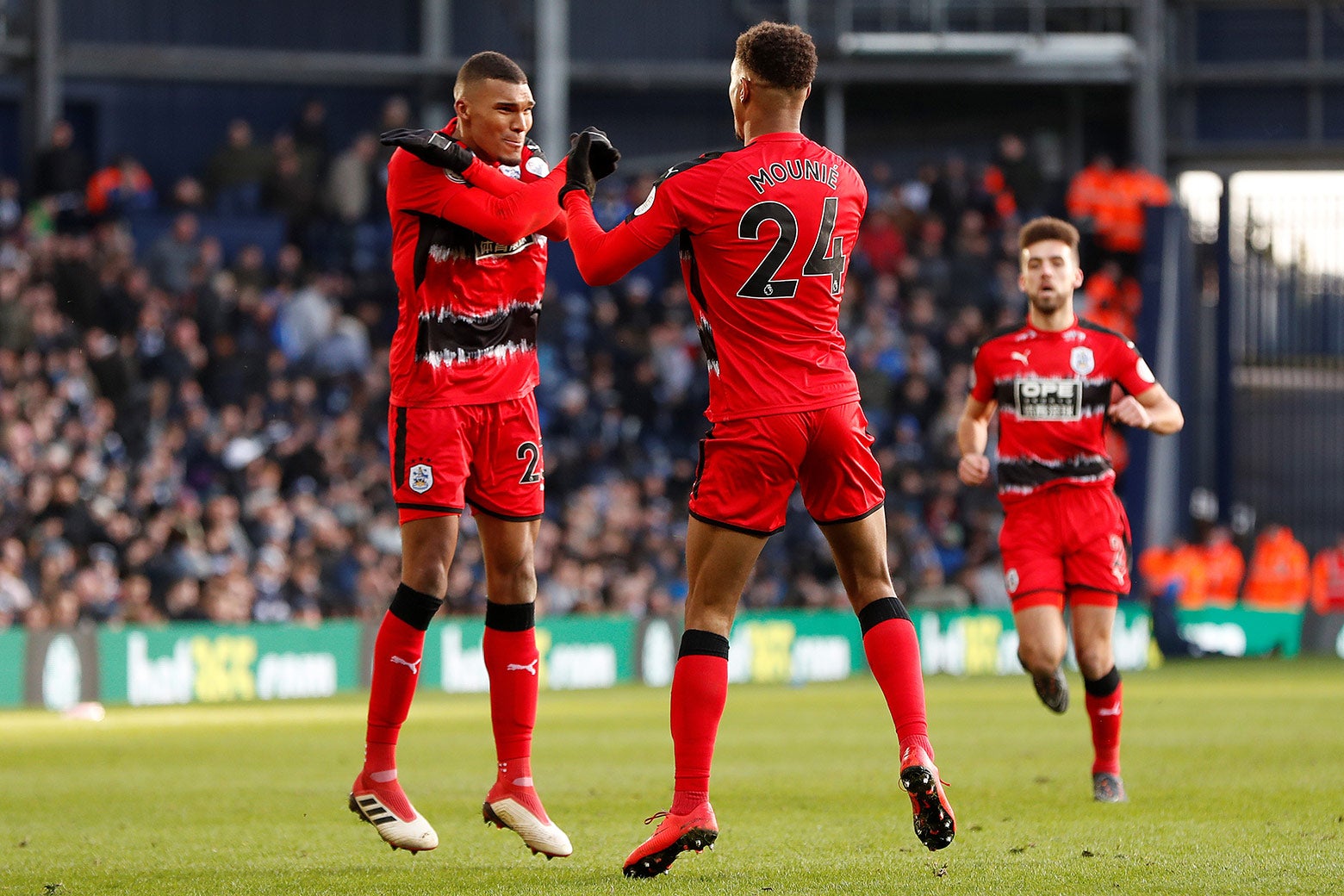 Huddersfield Town soccer players Steve Mounie and Colin Quaner celebrate a goal against West Bromwich Albion with the Wakanda salute, Feb. 24.