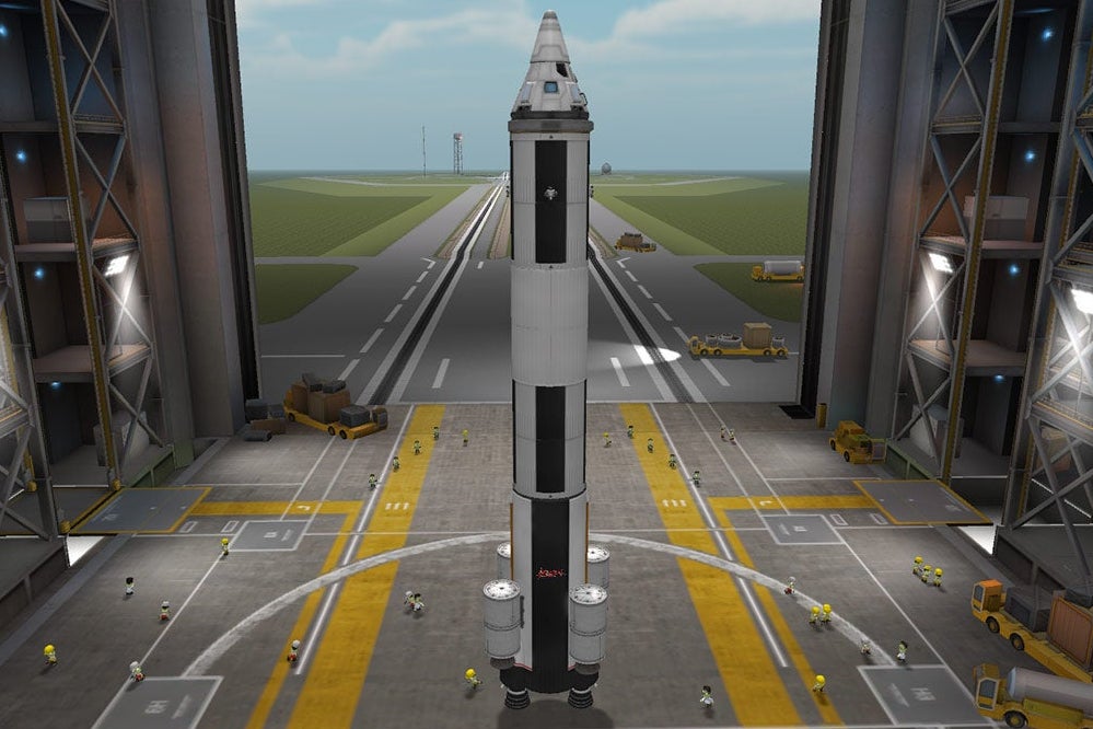 A rocket ship in Kerbal Space Program’s shipbuilding simulator. It is shaped like a pencil, with four rocket boosters attached to the bottom.