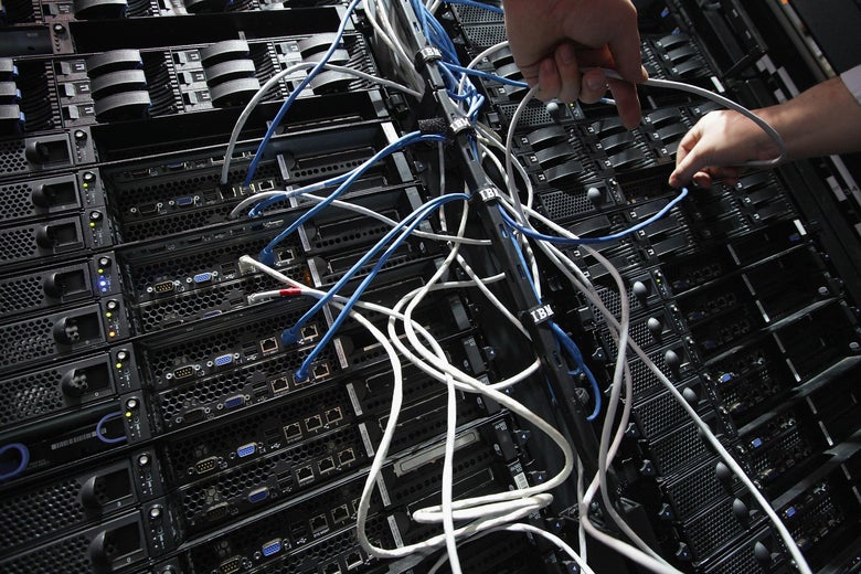 A worker connects server modules with cables