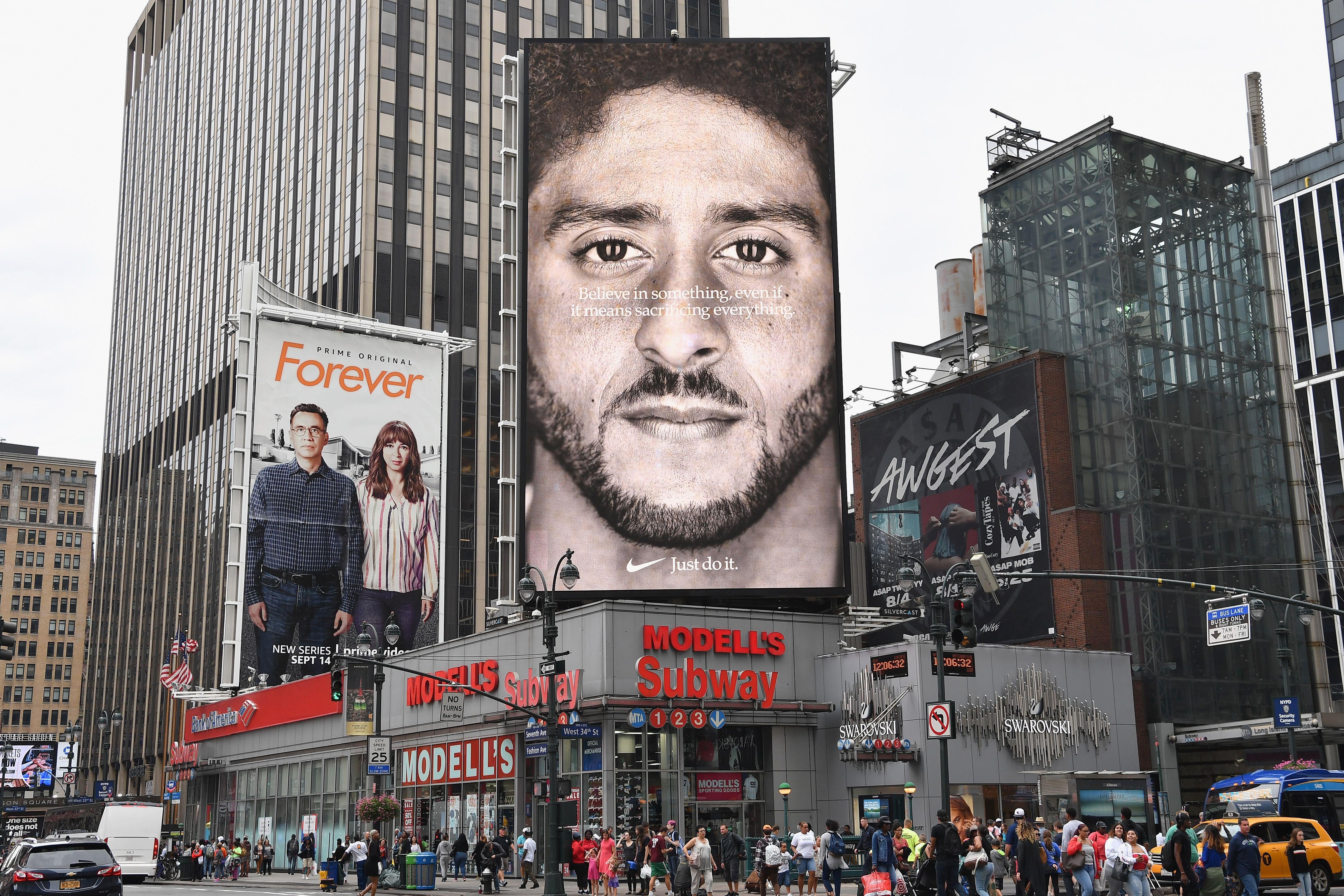 A Nike Ad showing Kaepernick's face stands above a New York City street corner.