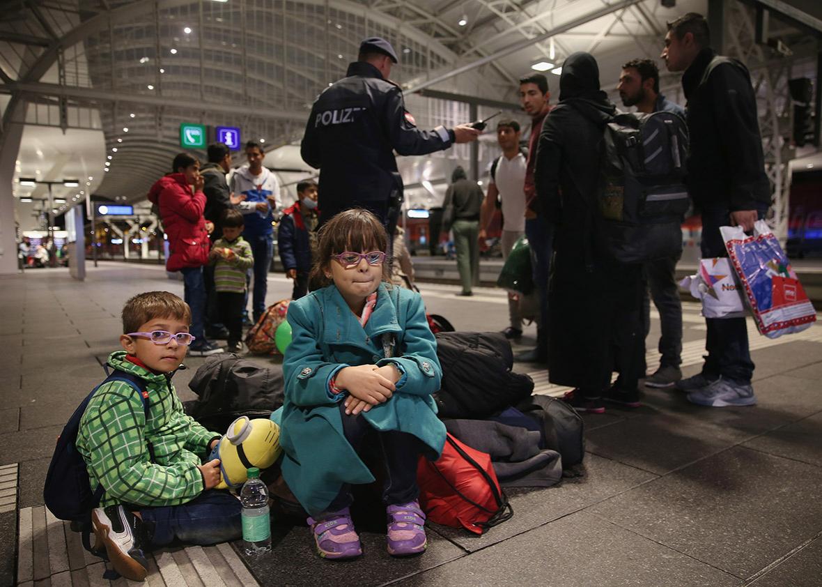 Syrian refugees wait on a railway platform at Salzburg Hauptbahnhof train station in the hope of catching a train to Germany on Sept. 14, 2015, in Salzburg, Austria.