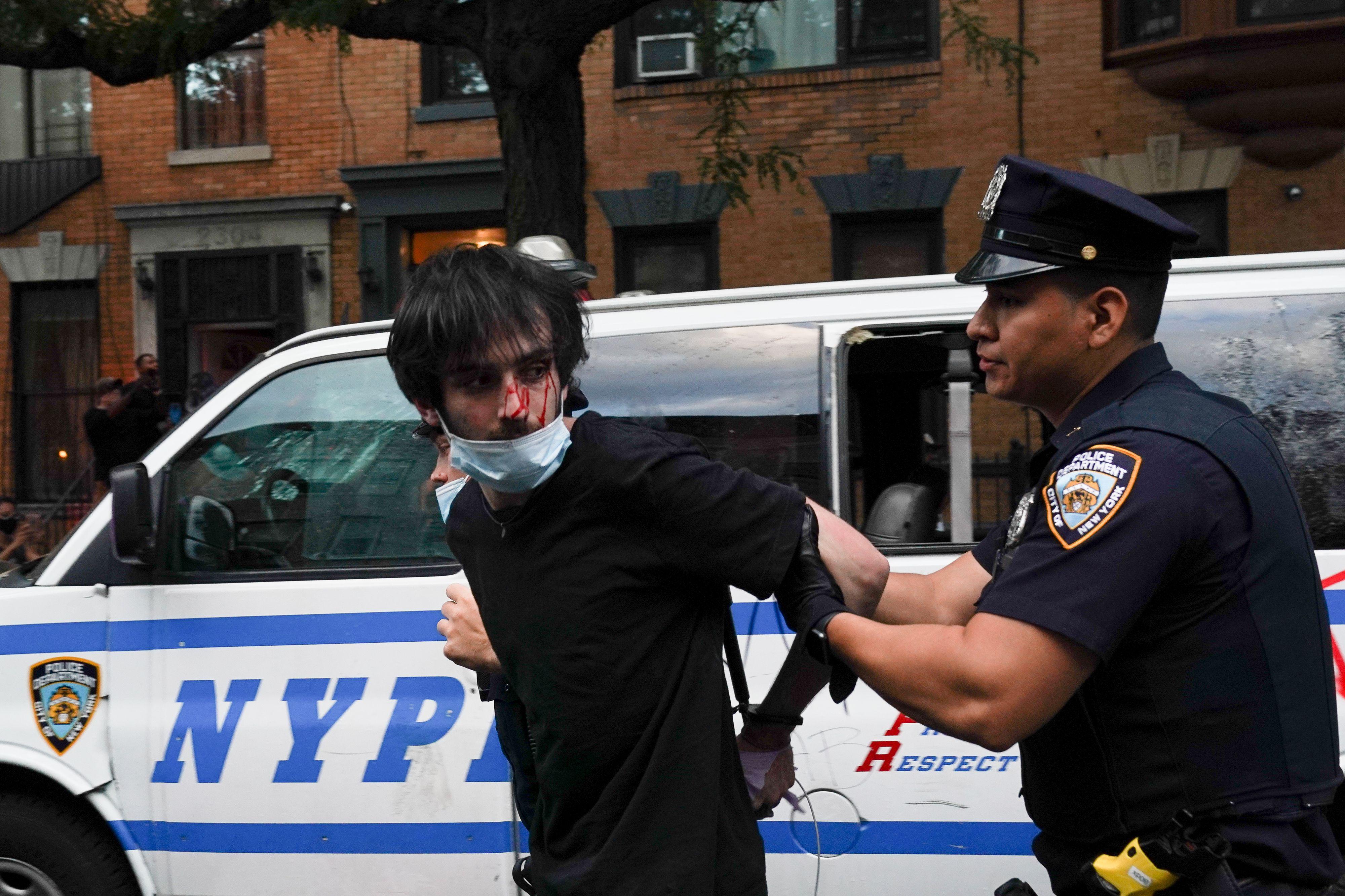 NYPD officers arrest protesters during a demonstration against the killing of George Floyd by Minneapolis police on May 30, 2020 in the Borough of Brooklyn in New York.