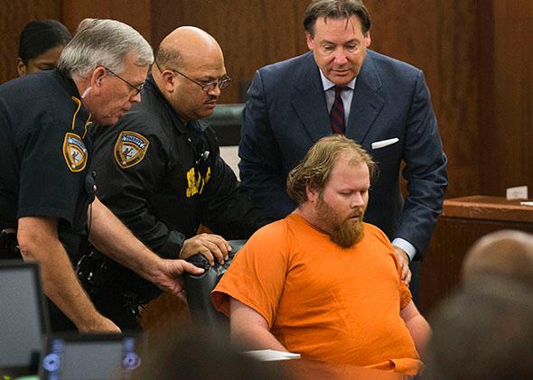 Accused mass shooter Ronald Lee Haskell is wheeled from the courtroom after collapsing during a hearing in Houston.