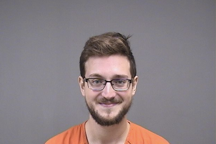 James Reardon smiling in his booking photo.