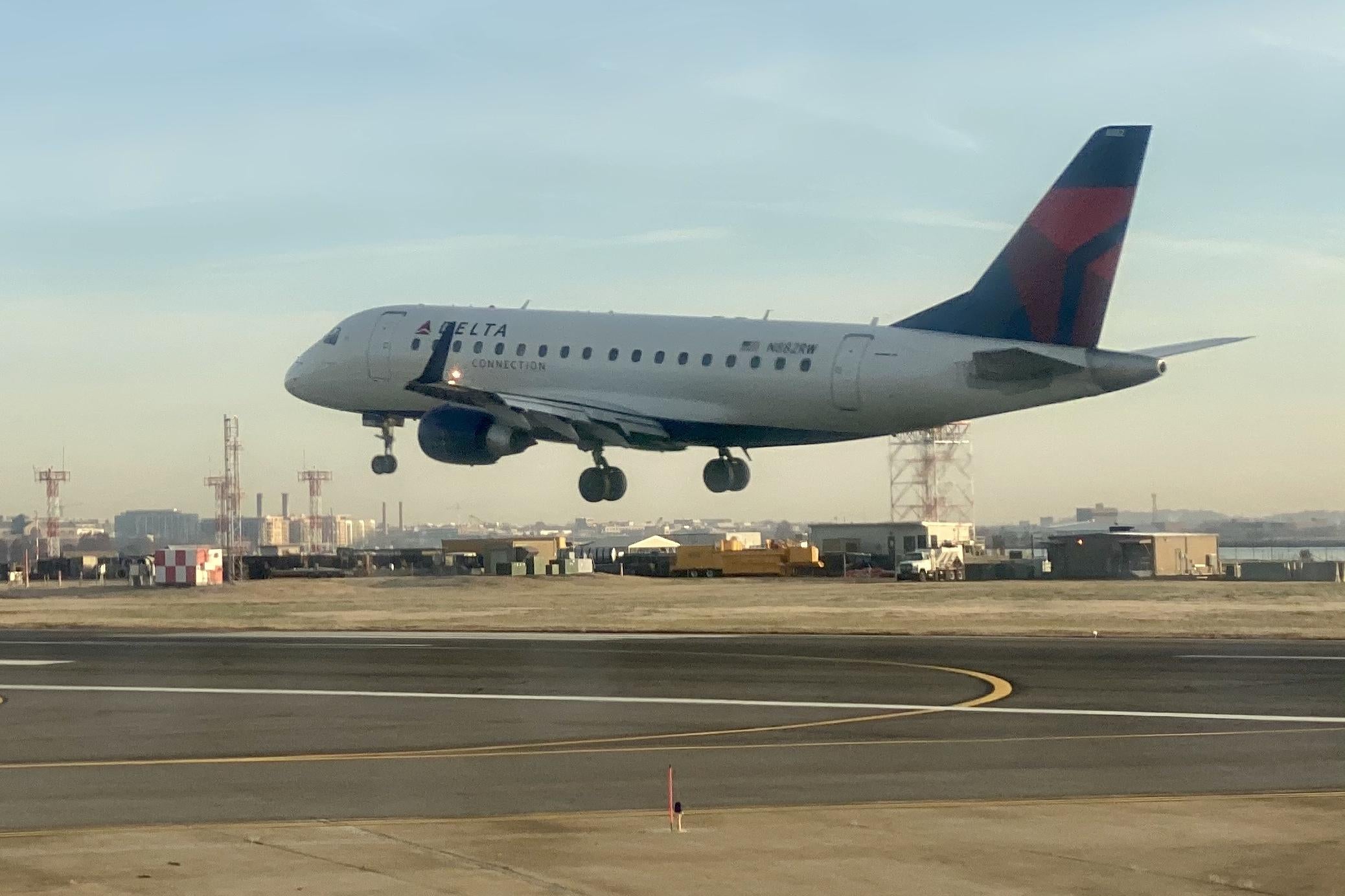 A Delta airplane lands at an airport.
