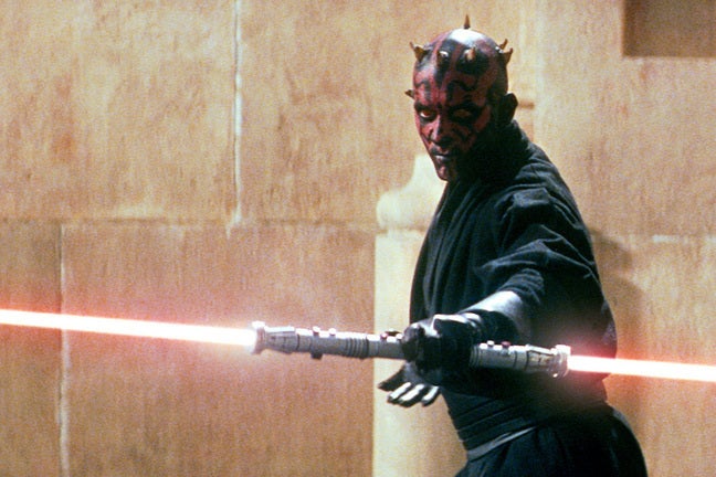 Ray Park as Darth Maul, with a double-bladed red lightsaber