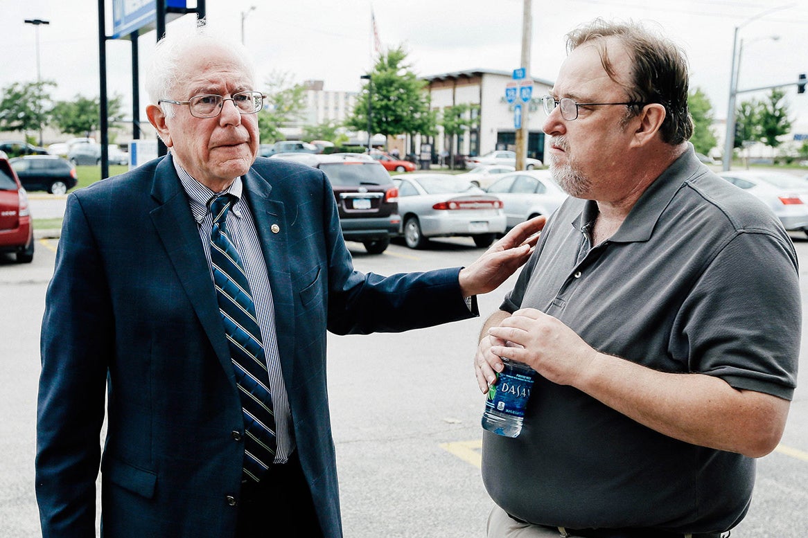 Bernie Sanders talks with his Iowa campaign coordinator Pete D'Alessandro, right, before speaking to supporters at an open house at his Iowa campaign headquarters, Saturday, June 13, 2015, in Des Moines, Iowa. (AP Photo/Charlie Neibergall)