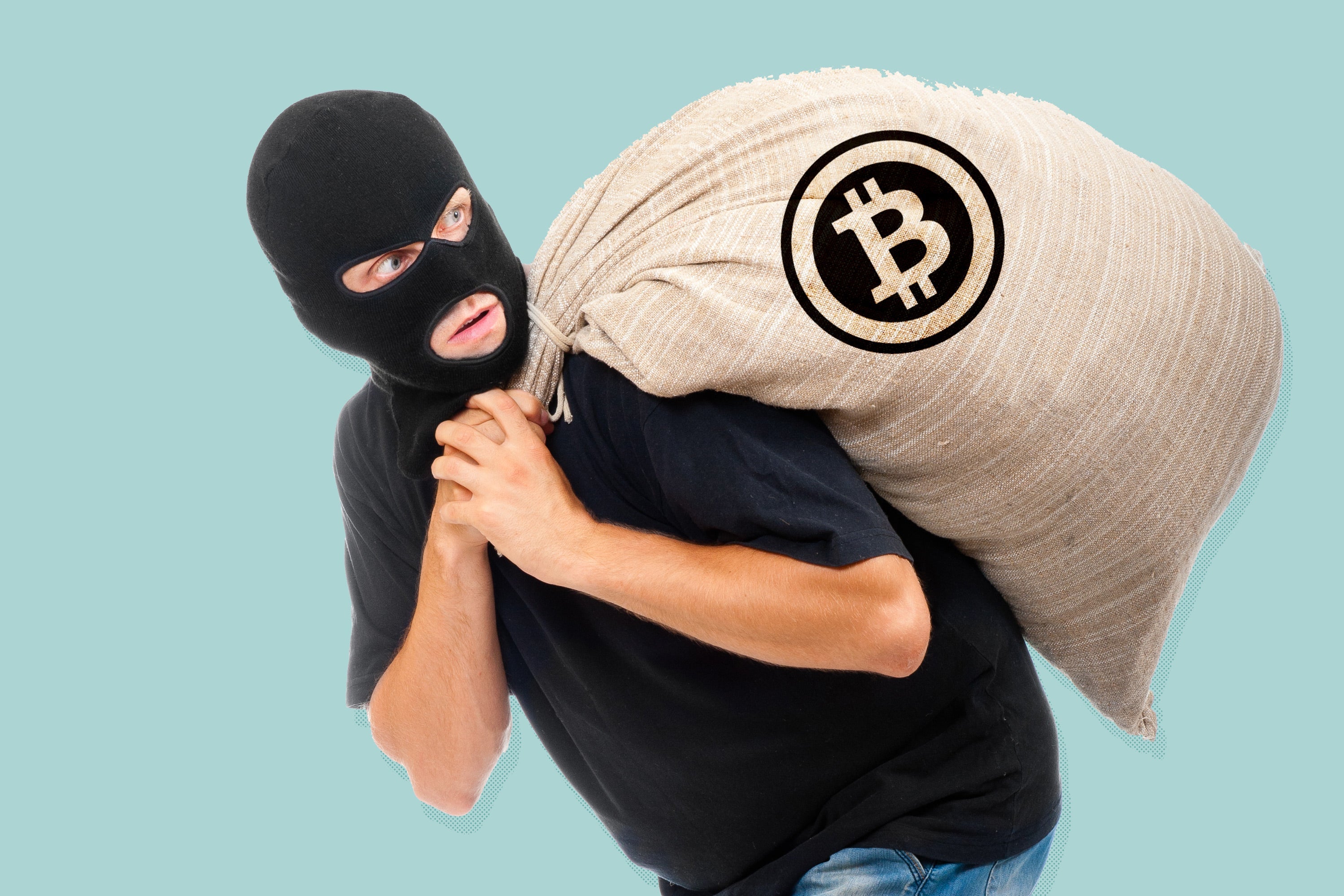 A man in a balaclava carries a burlap sack with a Bitcoin logo. 
