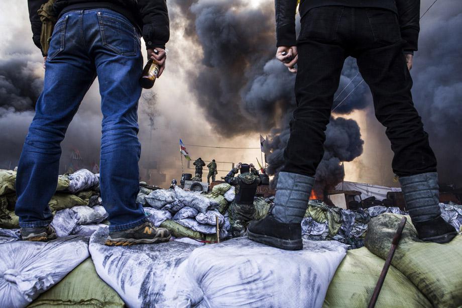 Demonstrators stand on barricades during clashes with riot police in Kiev on Feb. 18, 2014. 