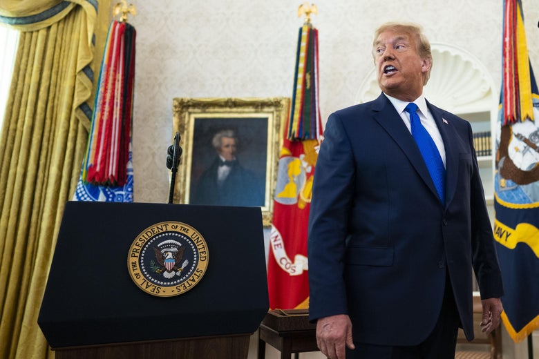 Trump with flags behind him