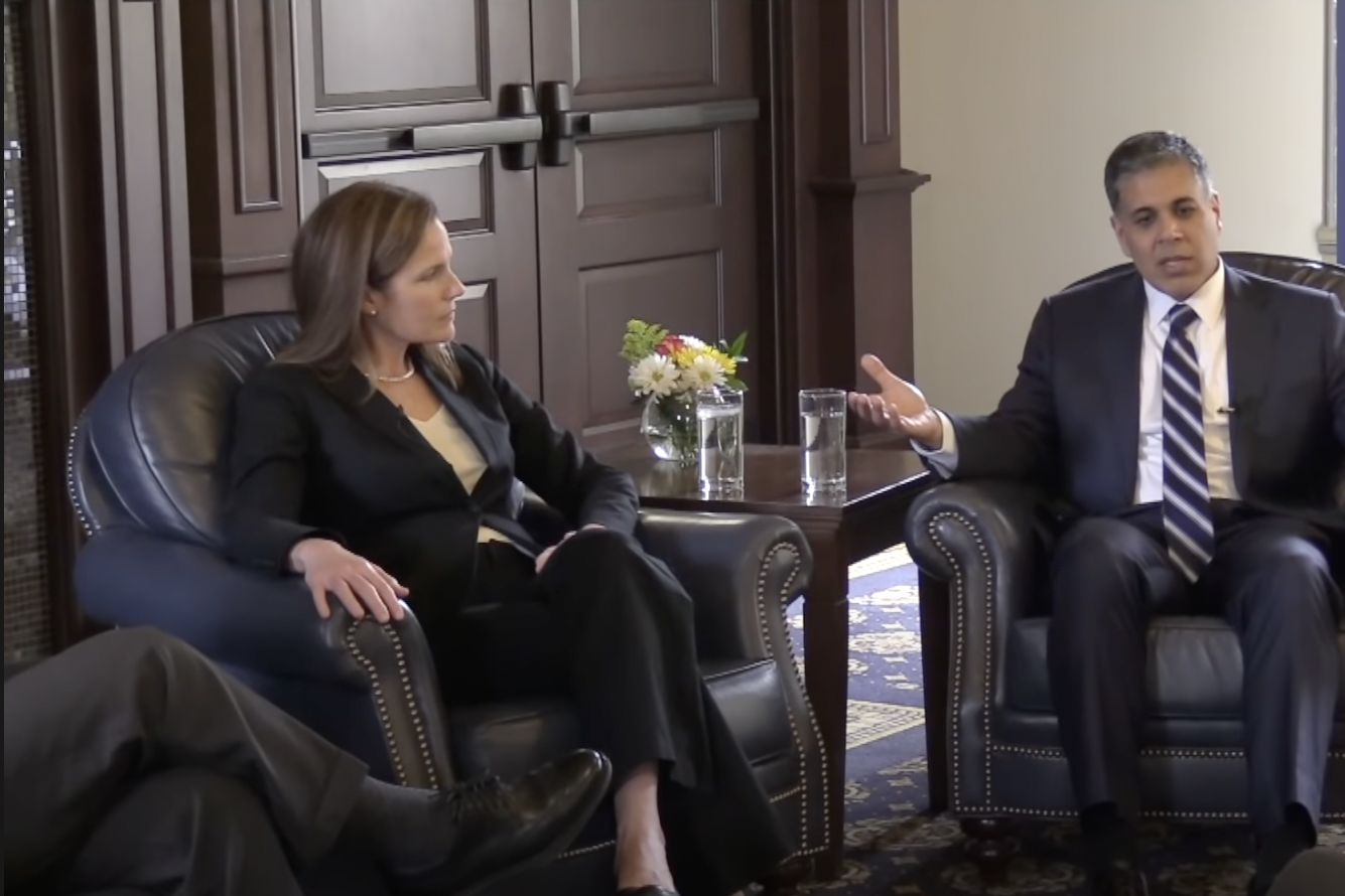 Amul Thapar and Amy Coney Barrett have a conversation while sitting down at a law school.