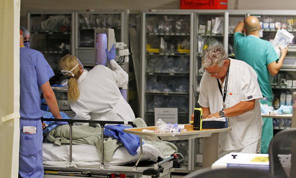 Doctors and nurses work on a patient in the Ryder Trauma Center at Jackson Memorial Hospital in Miami, Florida  September 30, 2013.