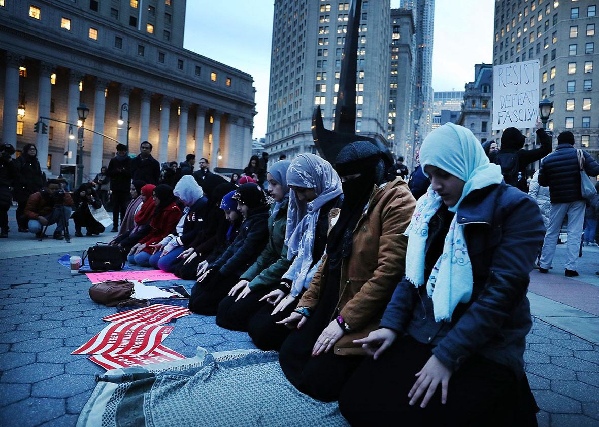 Muslim women pray before a protest in lower Manhattan against the polices of President Donald Trump on February 1, 2017 in New York City. 