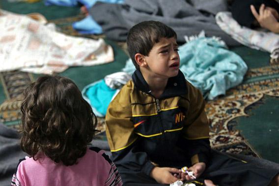 A boy who survived from what activists say is a gas attack cries as he takes shelter inside a mosque in the Duma neighbourhood of Damascus August 21, 2013.