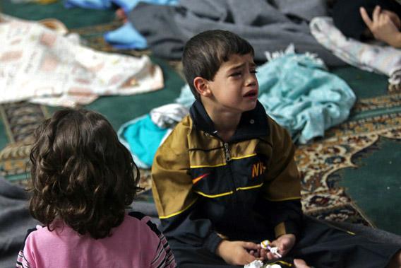 A boy who survived from what activists say is a gas attack cries as he takes shelter inside a mosque in the Duma neighbourhood of Damascus August 21, 2013. 