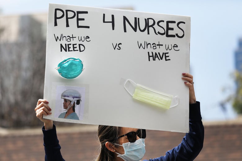A nurse holds up a sign to protest the lack of personal protective gear available at UCI Medical Center amid the coronavirus pandemic on April 3, 2020 in Orange, California. 