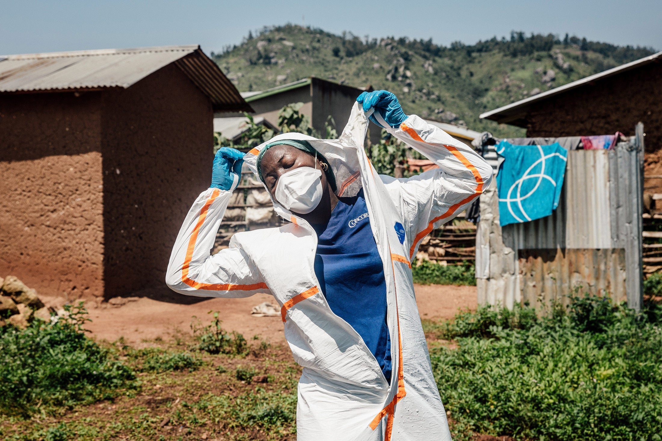 World Health Organization worker Belinda Landu changes her protective outfit.
