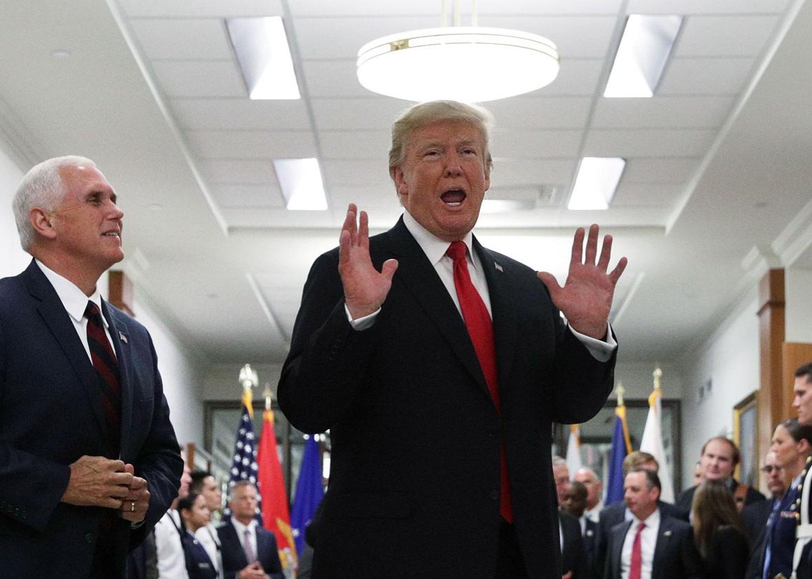 President Donald Trump speaks to members of the media as Vice President Mike Pence looks on after a meeting at the Pentagon on Thursday in Arlington, Virginia.