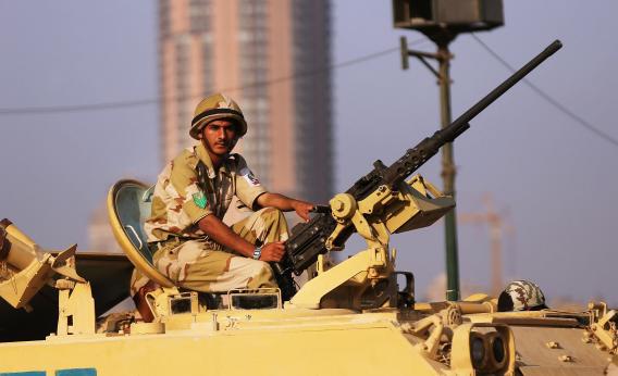 Members of the Egyptian military man an armored vehicle as they guard a bridge near Tahrir Square on July 8, 2013