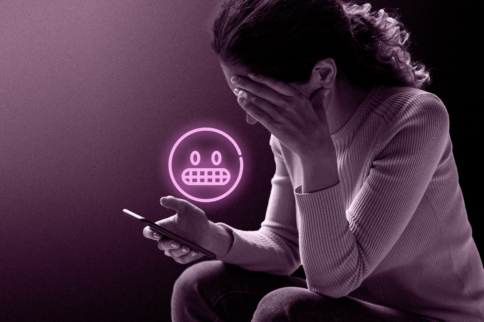 A woman looks forlorn while looking at her cell phone, or husband's cell phone, holds her head in her hands, with a neon pink emoji. 