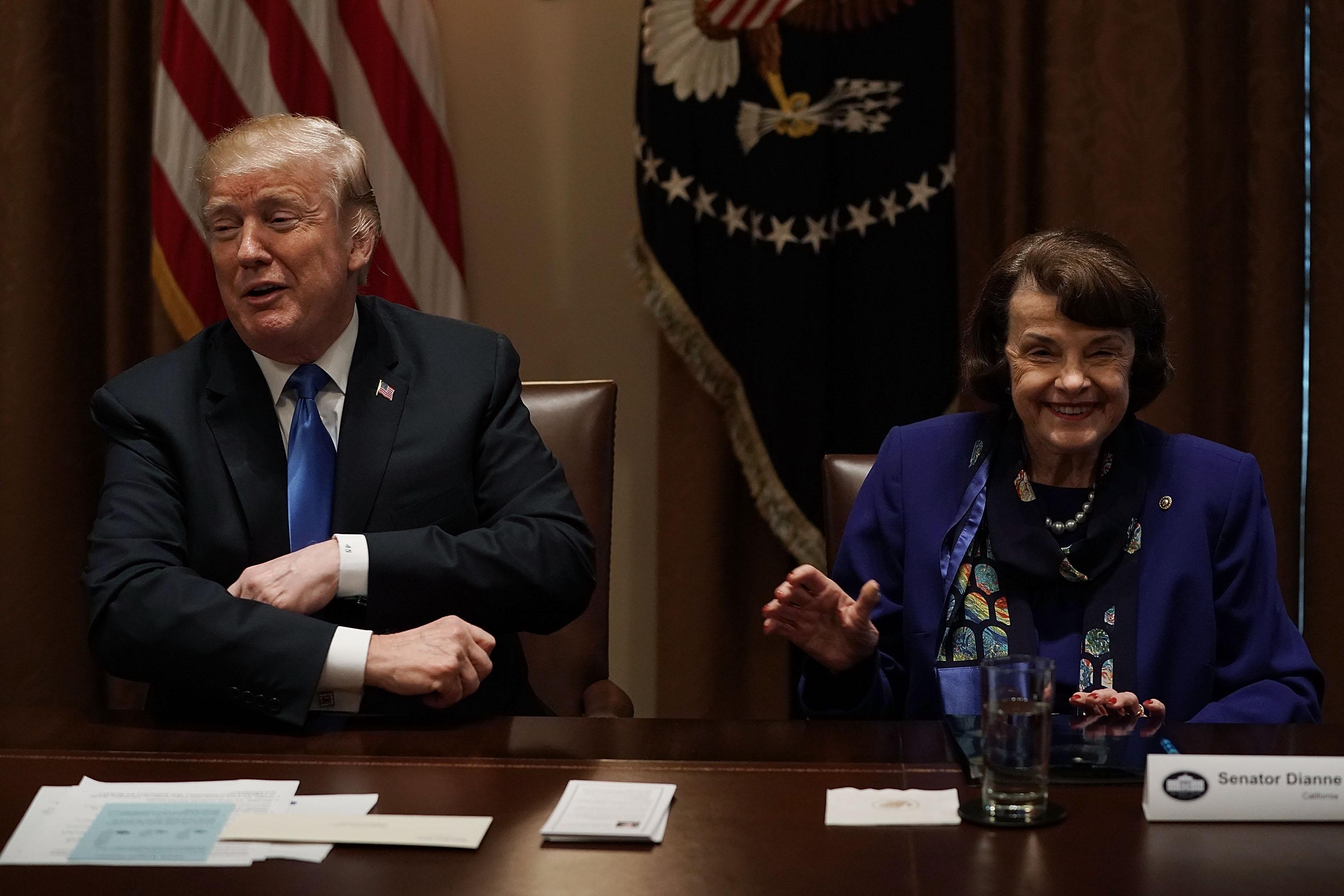WASHINGTON, DC - FEBRUARY 28:  U.S. U.S. President Donald Trump (L) and Sen. Dianne Feinstein (D-CA) (R) share a moment during a meeting with bipartisan members of the Congress at the Cabinet Room of the White House February 28, 2018 in Washington, DC. President Trump held a meeting with lawmakers to discuss school and community safety.  (Photo by Alex Wong/Getty Images)