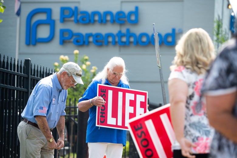 Anti-abortion demonstrators hold a protest outside the Planned Parenthood clinic.