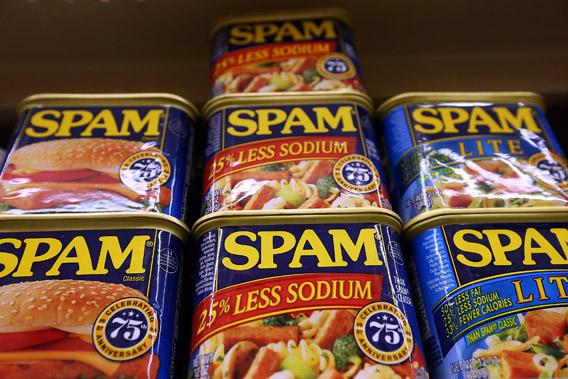 Cans of Spam are displayed on a shelf at Cal Mart grocery store.
