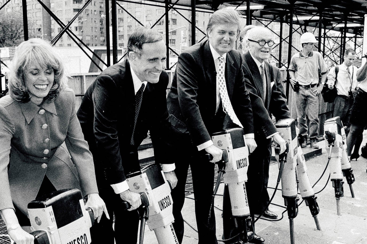 Giuliani, Trump, and others pose, holding jackhammers