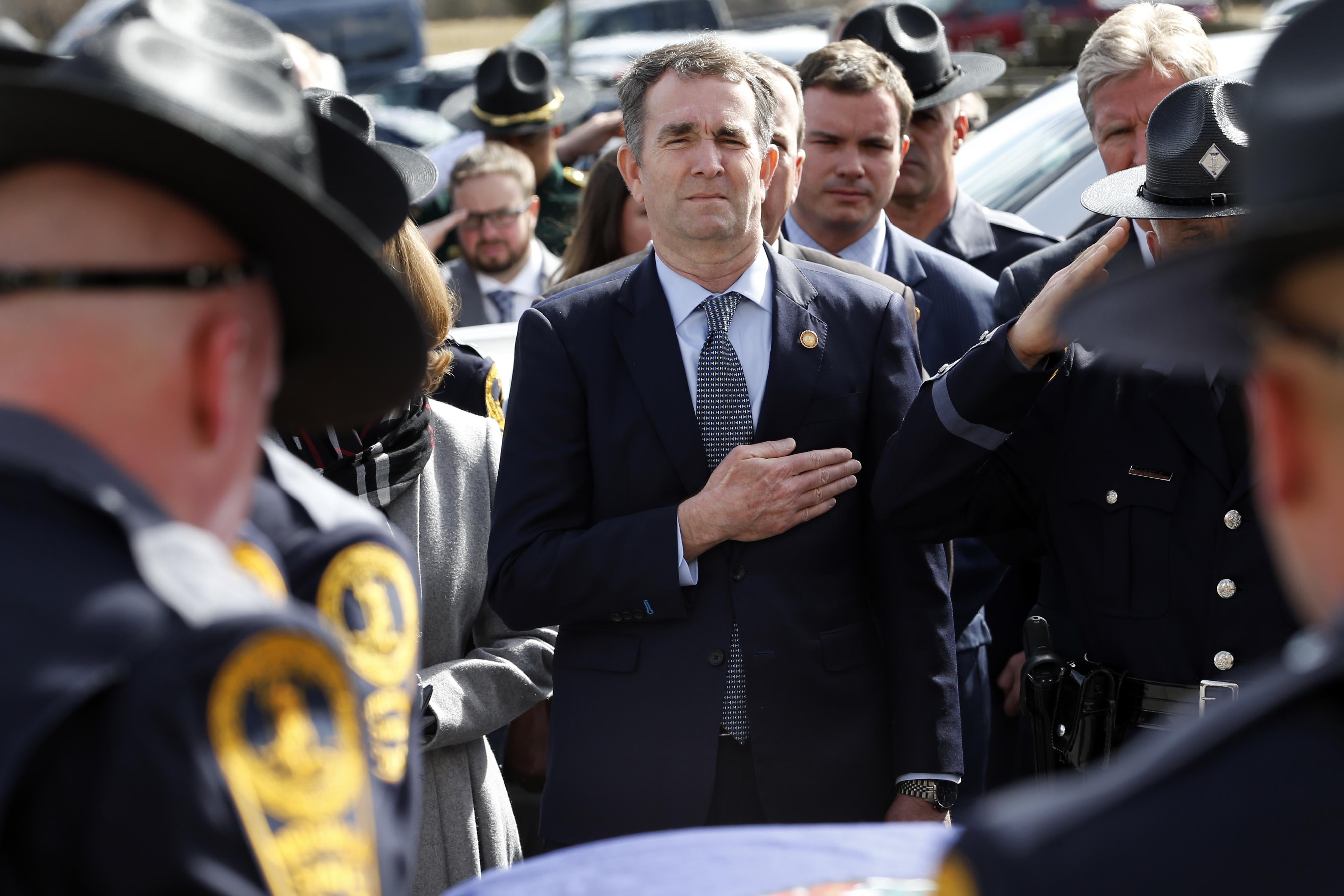 Virginia Gov. Ralph Northam watches as the casket of fallen Virginia State Trooper Lucas B. Dowell is carried to a waiting tactical vehicle during the funeral at the Chilhowie Christian Church on February 9, 2019 in Chilhowie, Virginia.