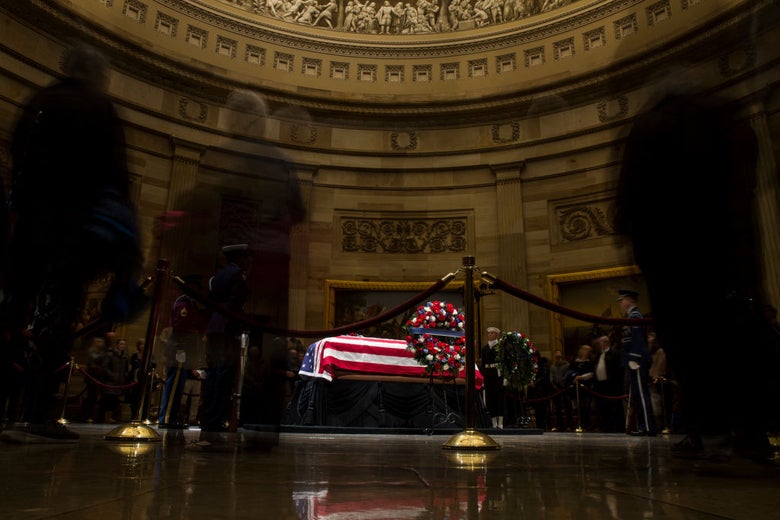 A flag-draped coffin in the Capitol rotunda.