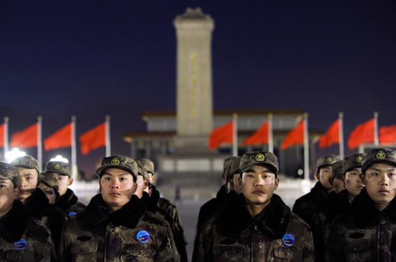 Chinese soldiers stand in line as they prepare to watch the daily flag-raising ceremony on New Year's Day on Tiananmen Square in Beijing.