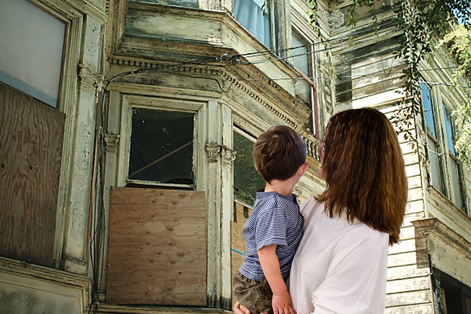 A woman holds her young son and looks at a boarded-up, for-sale house.