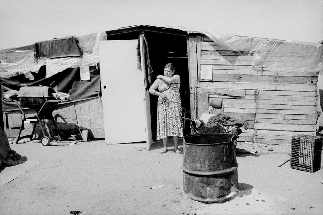 Woman at her shantytown home in Fresno, California.