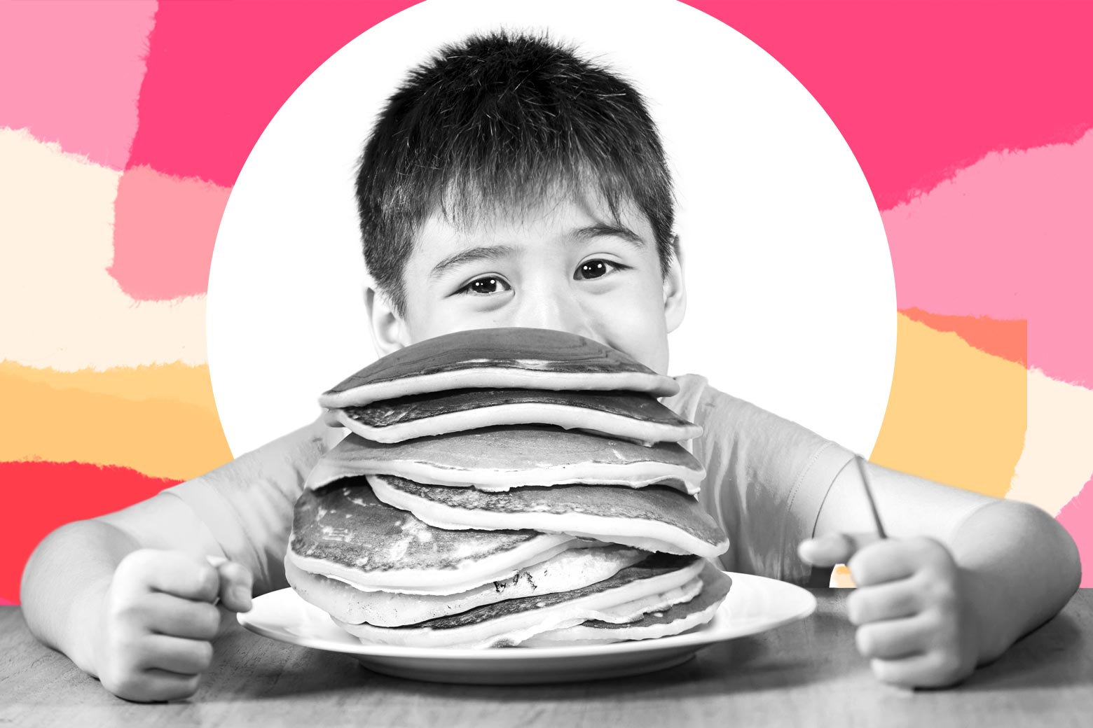 Boy eating a huge stack of pancakes. 
