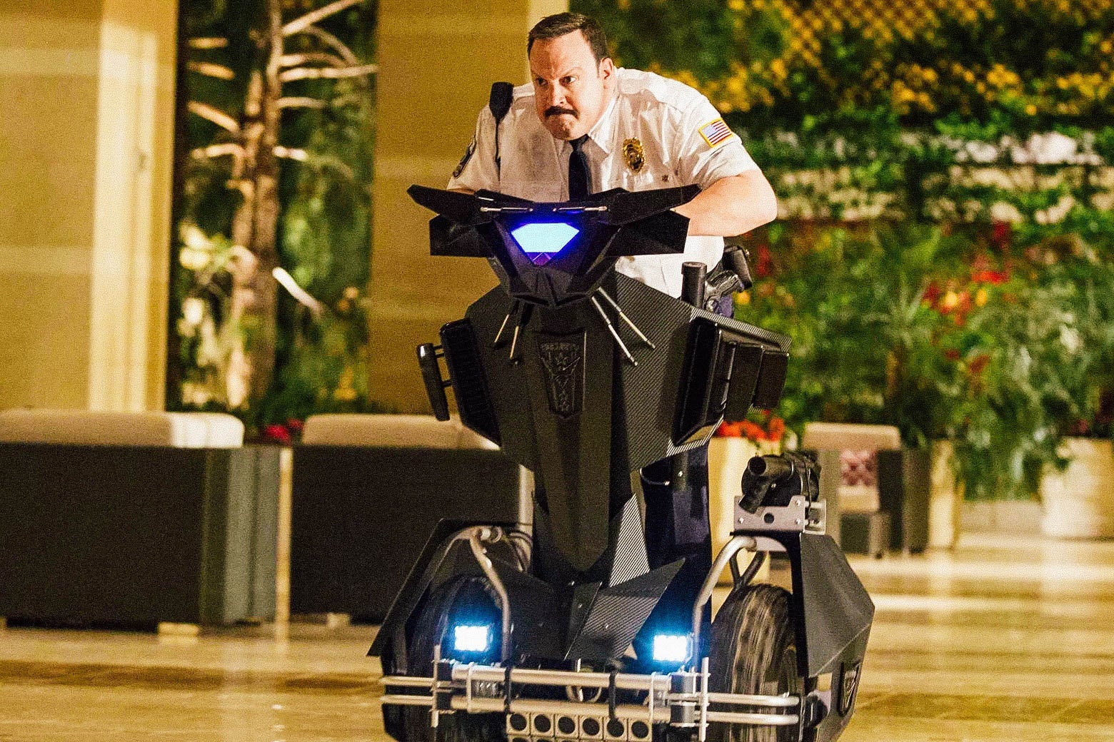 Kevin James leans forward on a Segway as he motors through the mall.