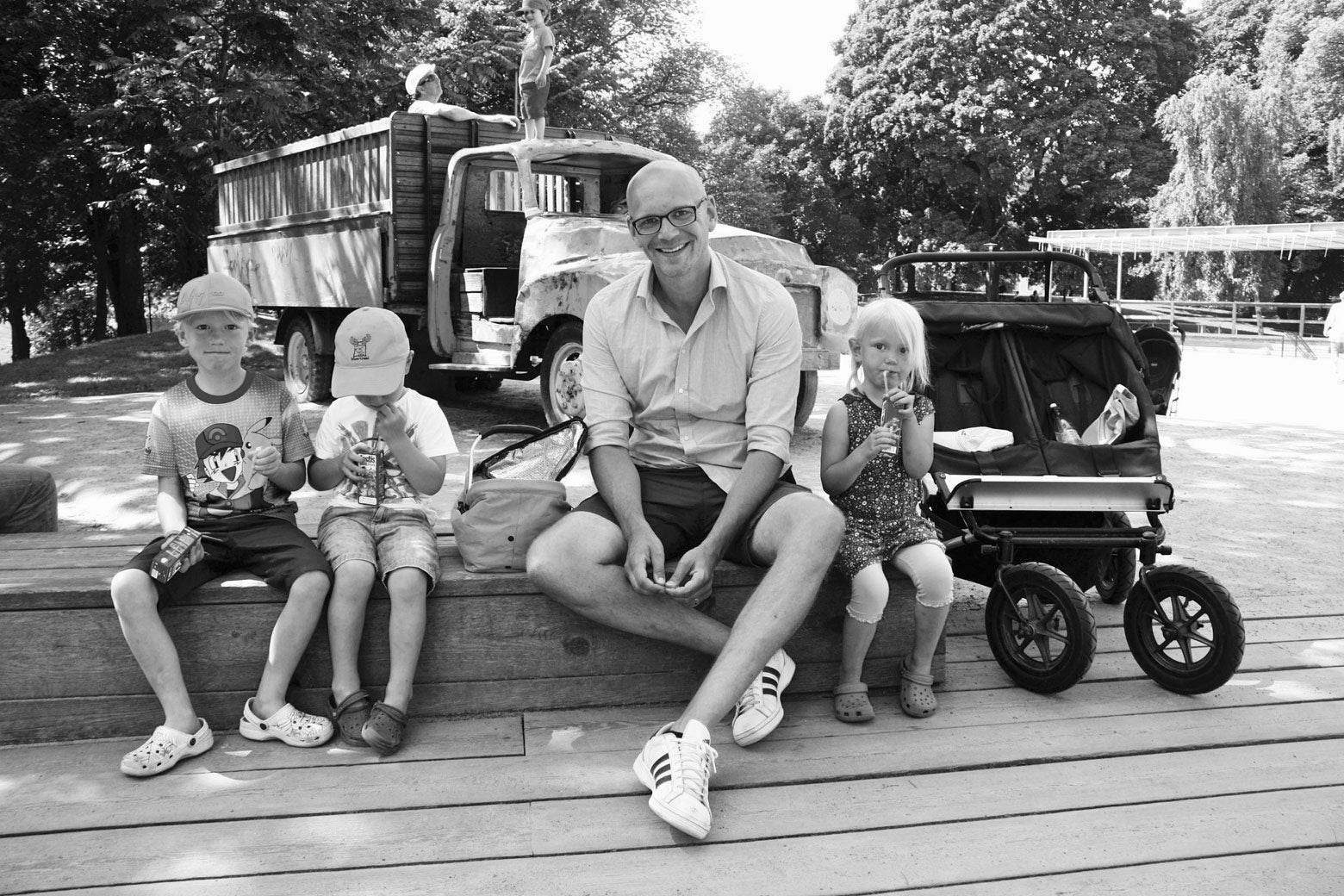  Siblings enjoy a lunch break with their father at a park in the Odenplan neighborhood of Stockholm. 