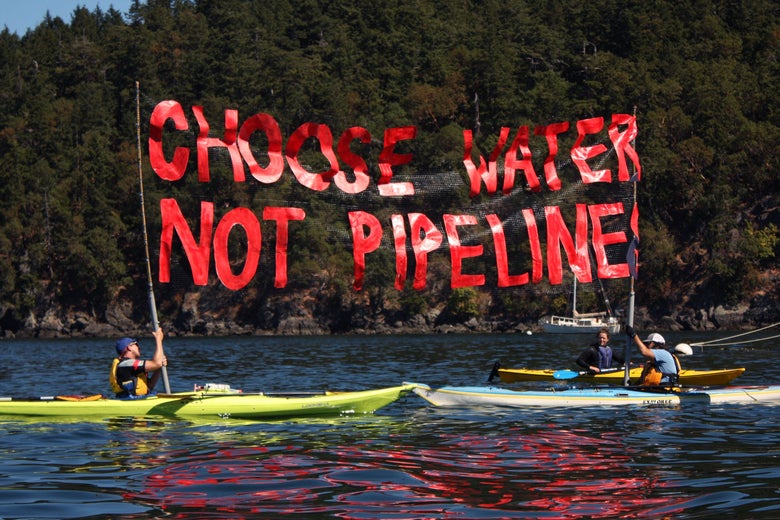 'Kayaktivists', including Greenpeace's Charles Latimer (right) hold up a "Choose Water Not Pipeline" banner during a water-based "pipeline resistance training camp."
