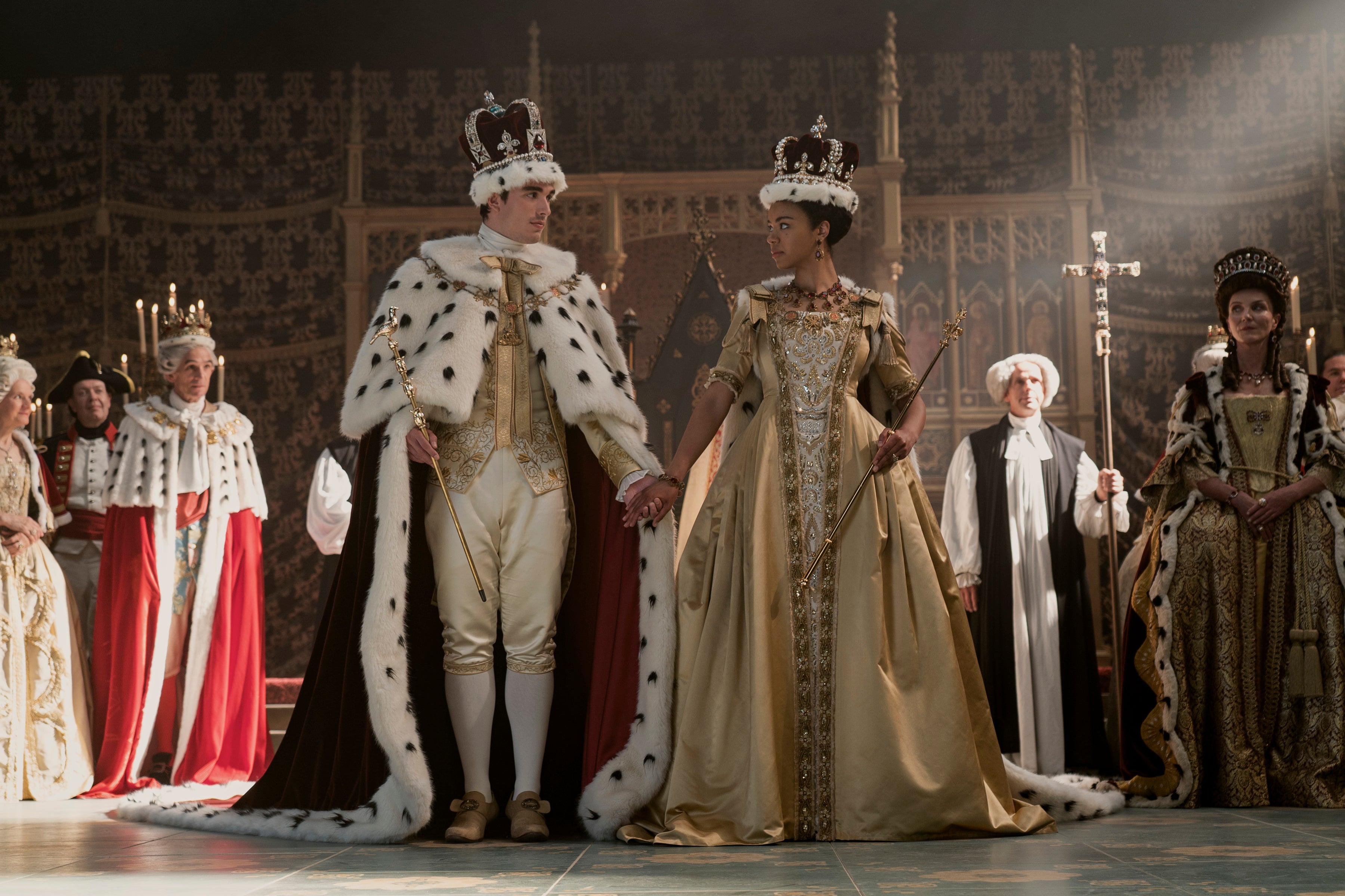 A white king and a Black queen stand at a coronation.