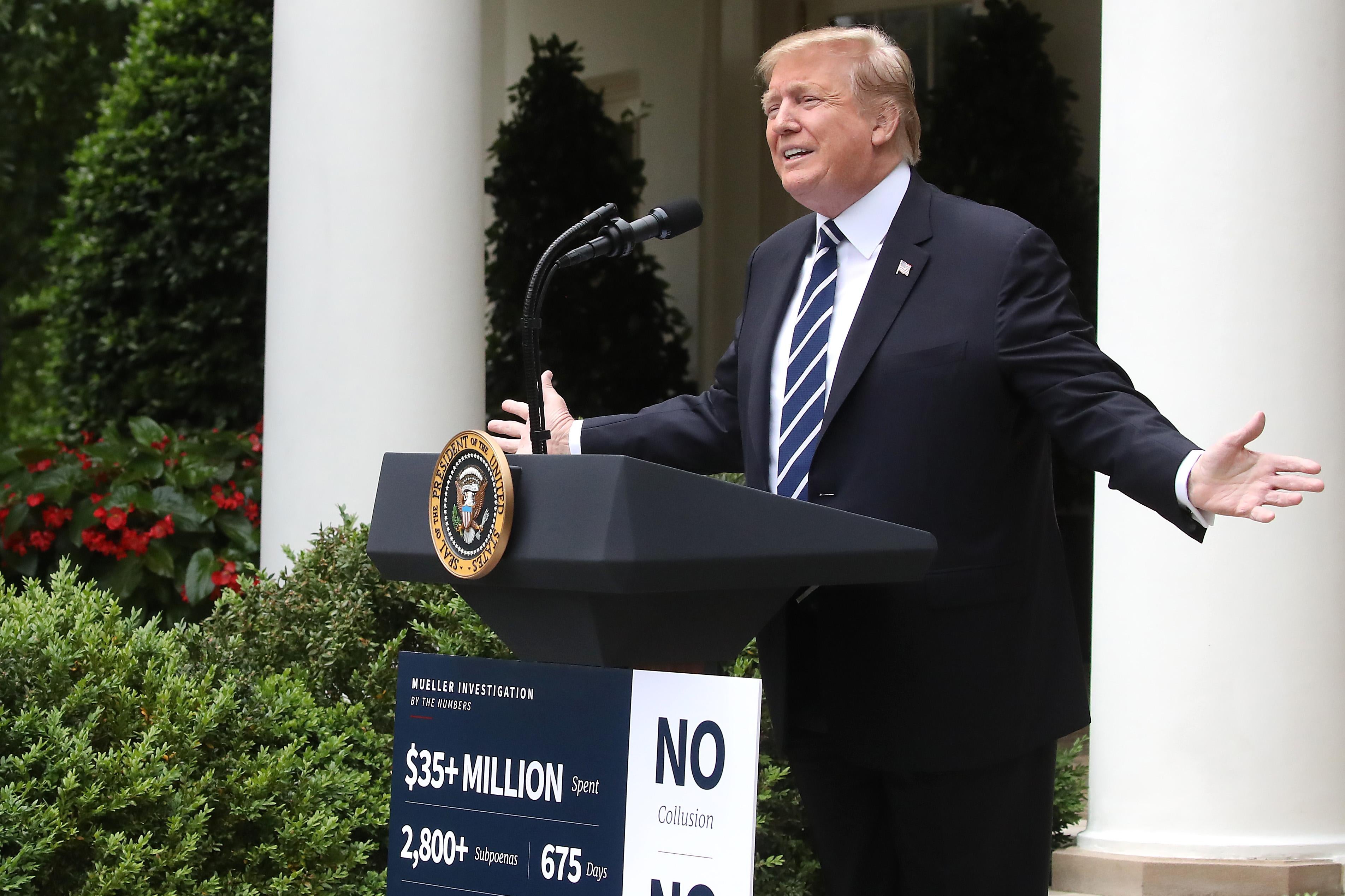 President Trump speaks from behind a podium in the White House Rose Garden.