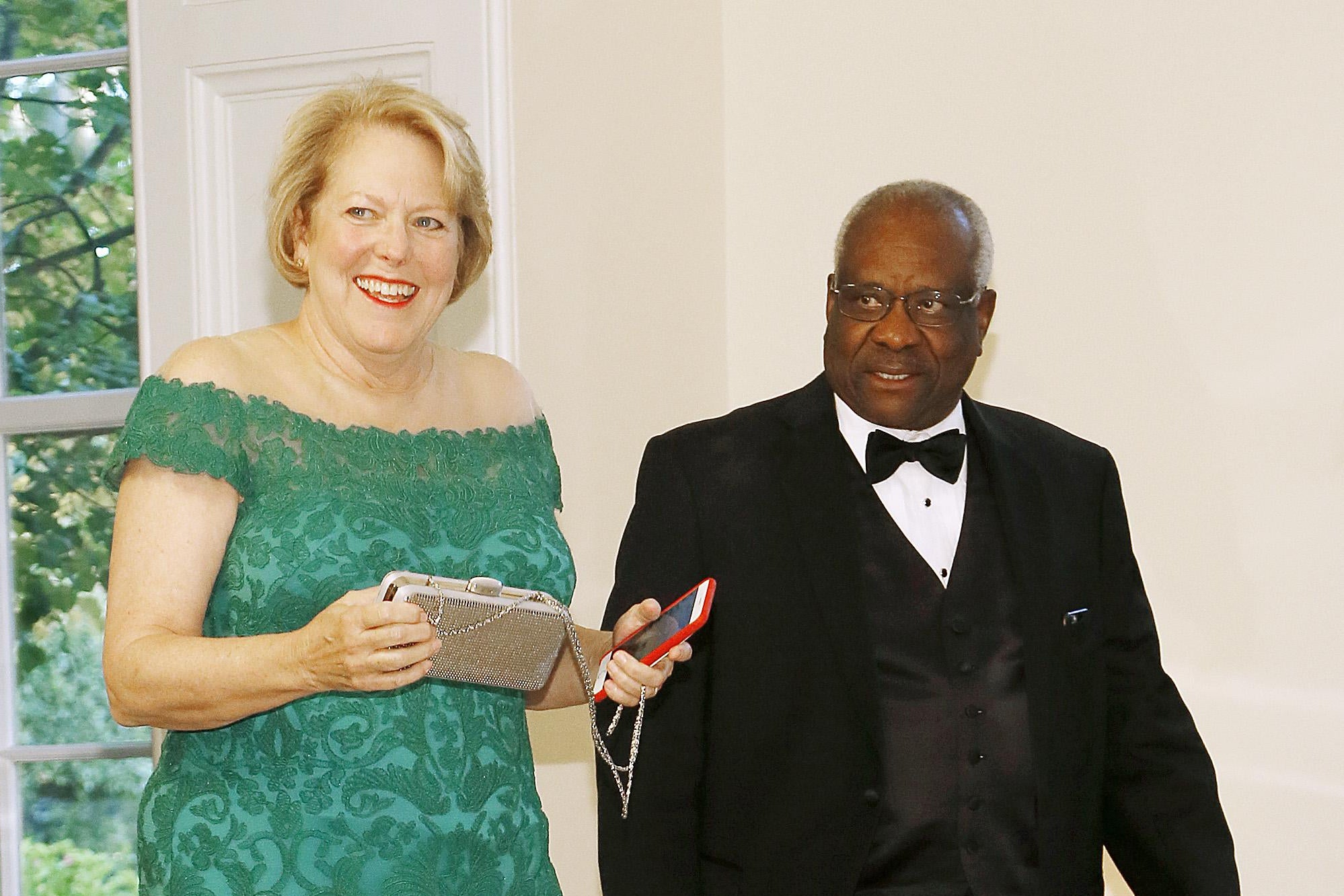 Clarence in a tux, Ginni smiling in a green gown